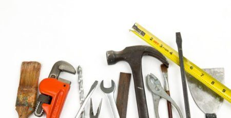 Assortment of tools - hammer, brush, pliers, wrenches, etc.