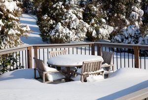 Snow covered deck and deck furniture