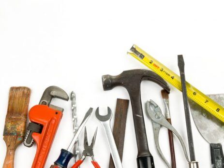 Assortment of tools - hammer, brush, pliers, wrenches, etc.