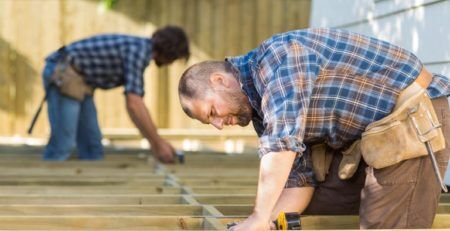 2 carpenters building a new deck