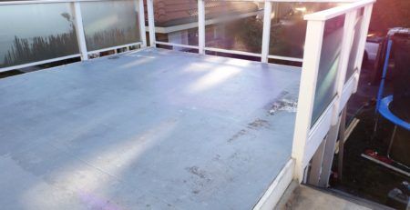 Flat roof deck with damaged flooring