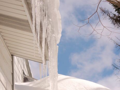 LARGE ICICLES AND SNOW ON ROOF EDGE