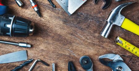 IMAGE OF VARIOUS TOOLS ON WOODEN SURFACE - HIRE A PRO OR DIY A NEW VINYL DECK - TUFDEK