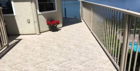 View of a lake from newly resurfaced deck featuring waterproof vinyl decking