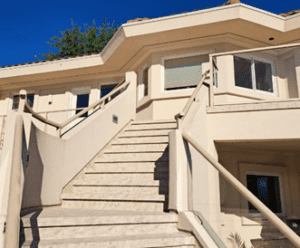 An exterior staircase and deck protected with new waterproof outdoor vinyl decking.