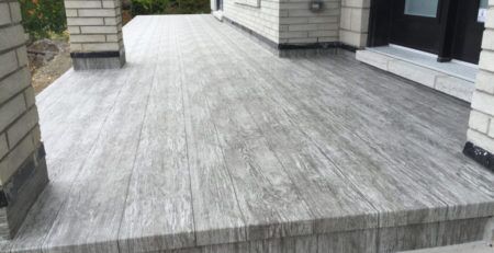 Finished vinyl wood plank decking on the front deck of a home