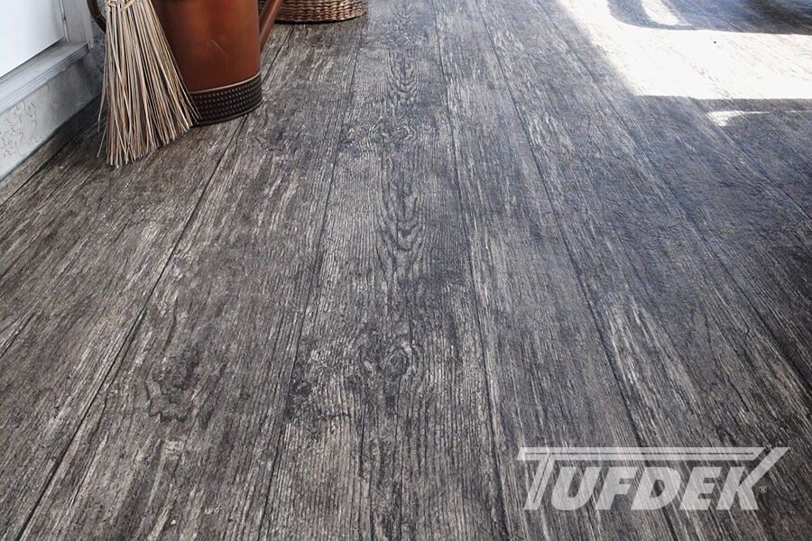 Why a New Vinyl Deck Makes Sense Rustic vinyl plank flooring installed by Tufdek