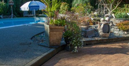 Patio next to a pool covered with outdoor waterproof vinyl decking