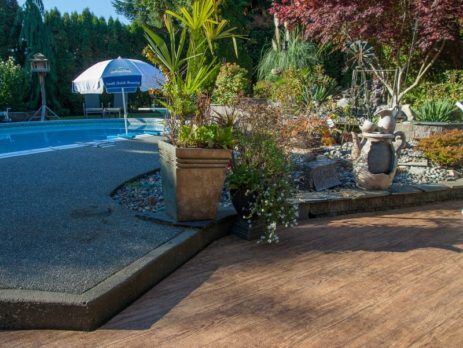 Patio next to a pool covered with outdoor waterproof vinyl decking