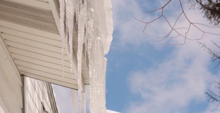 LARGE ICICLES AND SNOW ON ROOF EDGE