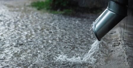 RAINWATER POURING OUT OF DOWN PIPE