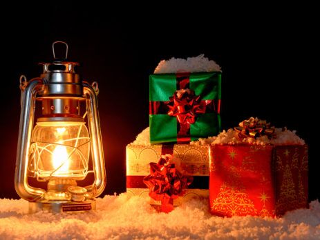 Lantern and Christmas gifts sitting in snow