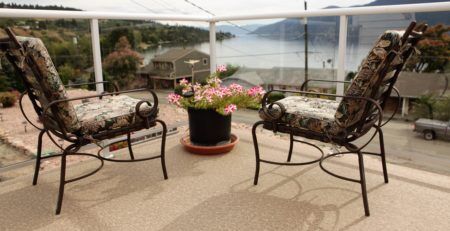 2 deck chairs and potted flowers on a newly covered vinyl deck