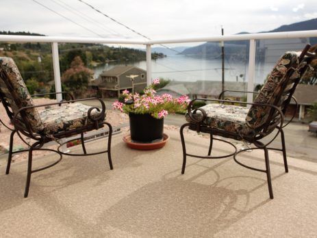 2 deck chairs and potted flowers on a newly covered vinyl deck