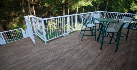 Green deck chairs and table on newly installed waterproof vinyl deck