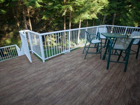 Green deck chairs and table on newly installed waterproof vinyl deck