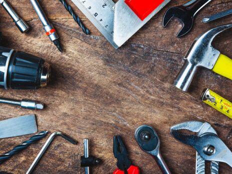 IMAGE OF VARIOUS TOOLS ON WOODEN SURFACE - HIRE A PRO OR DIY A NEW VINYL DECK - TUFDEK