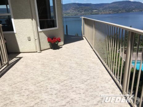 View of a lake from newly resurfaced deck featuring waterproof vinyl decking